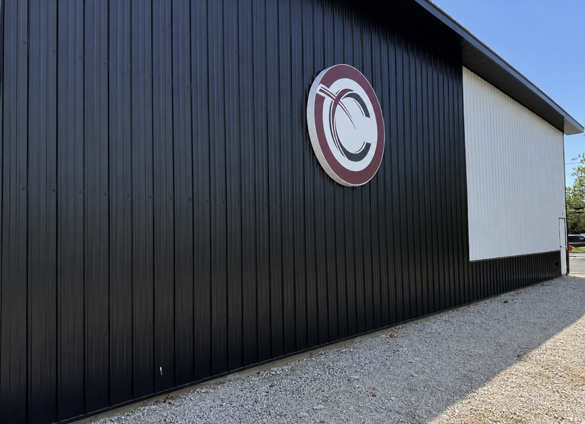 Custom dimensional circle logo signage installed on church building